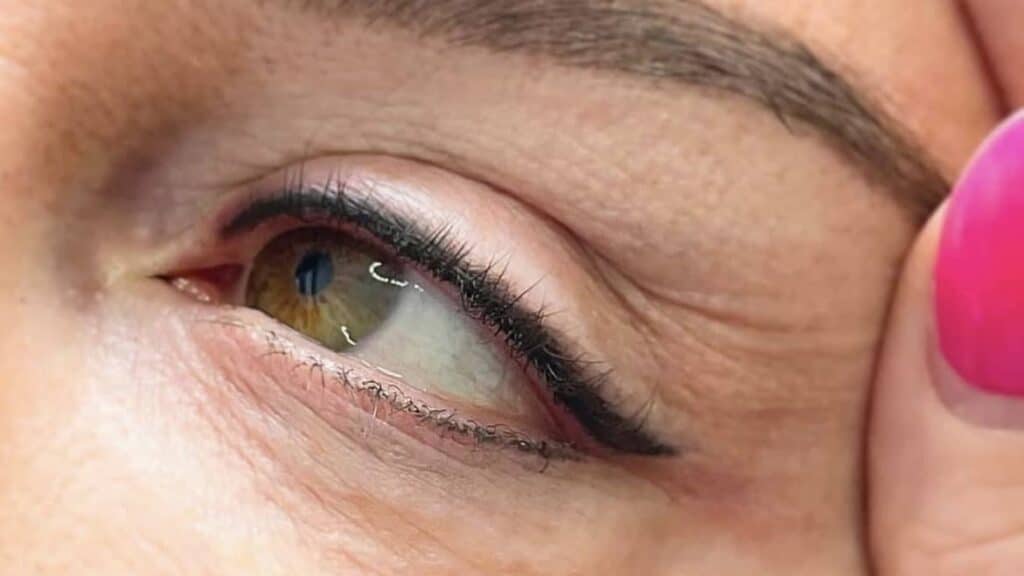 a closeup of a customer's eye after permanent eyeliner makeup has been applied