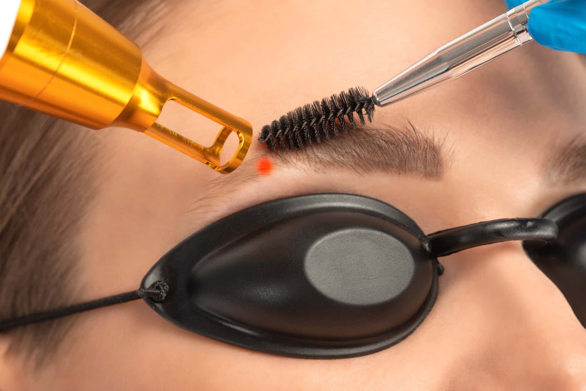 Removal of permanent makeup on the eyebrows of a woman.Carbon face peeling in a beauty salon. Hardware cosmetology treatment.