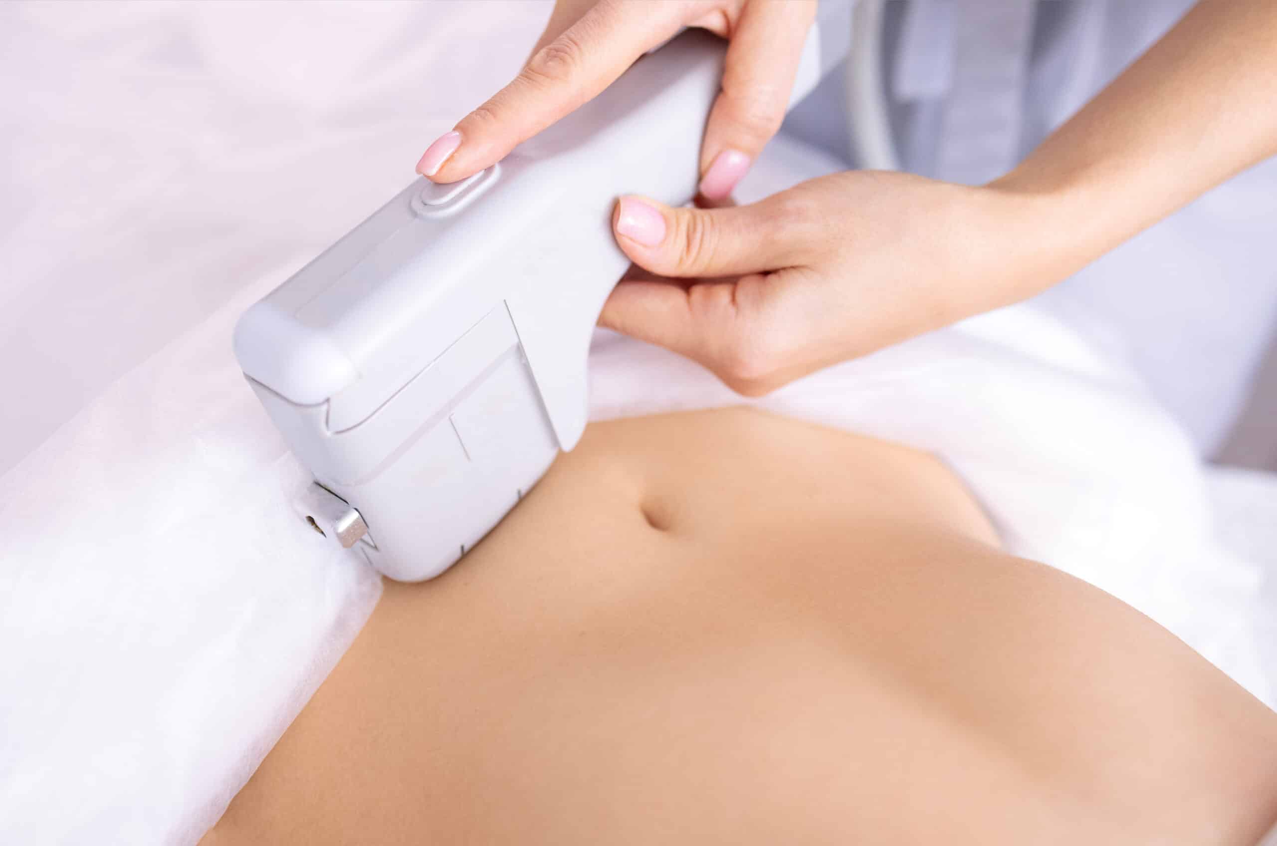 Portrait of relaxed young female client getting SMAS ultrasound face lifting massage of the body with professional equipment in beauty center